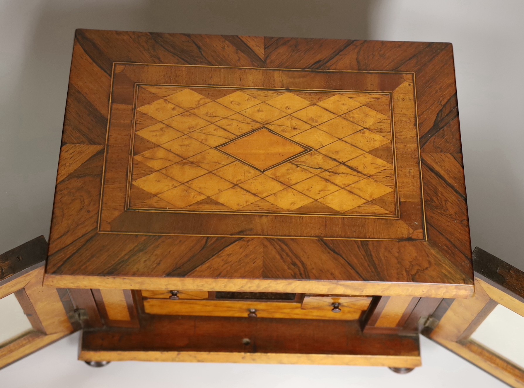 A 19th century rosewood and bird’s eye maple table cabinet. 24cm high. 32cm wide, 23cm deep